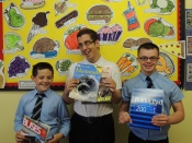 Three of the boys display items they bought with their vouchers.